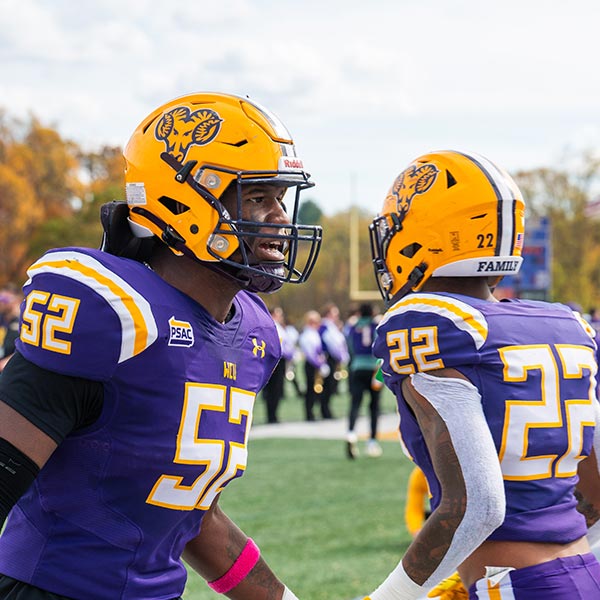 WCU football Players highfiving before the game