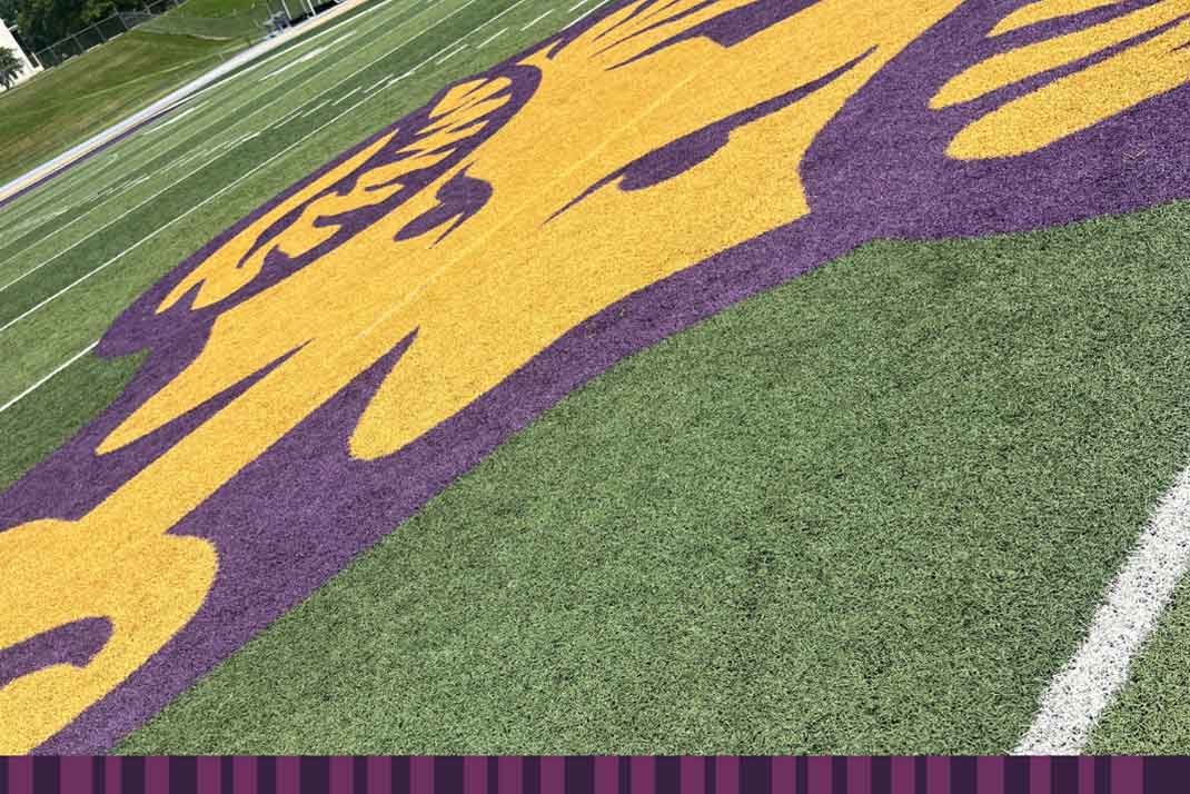 WCU Cheearleaders running with WCU flags