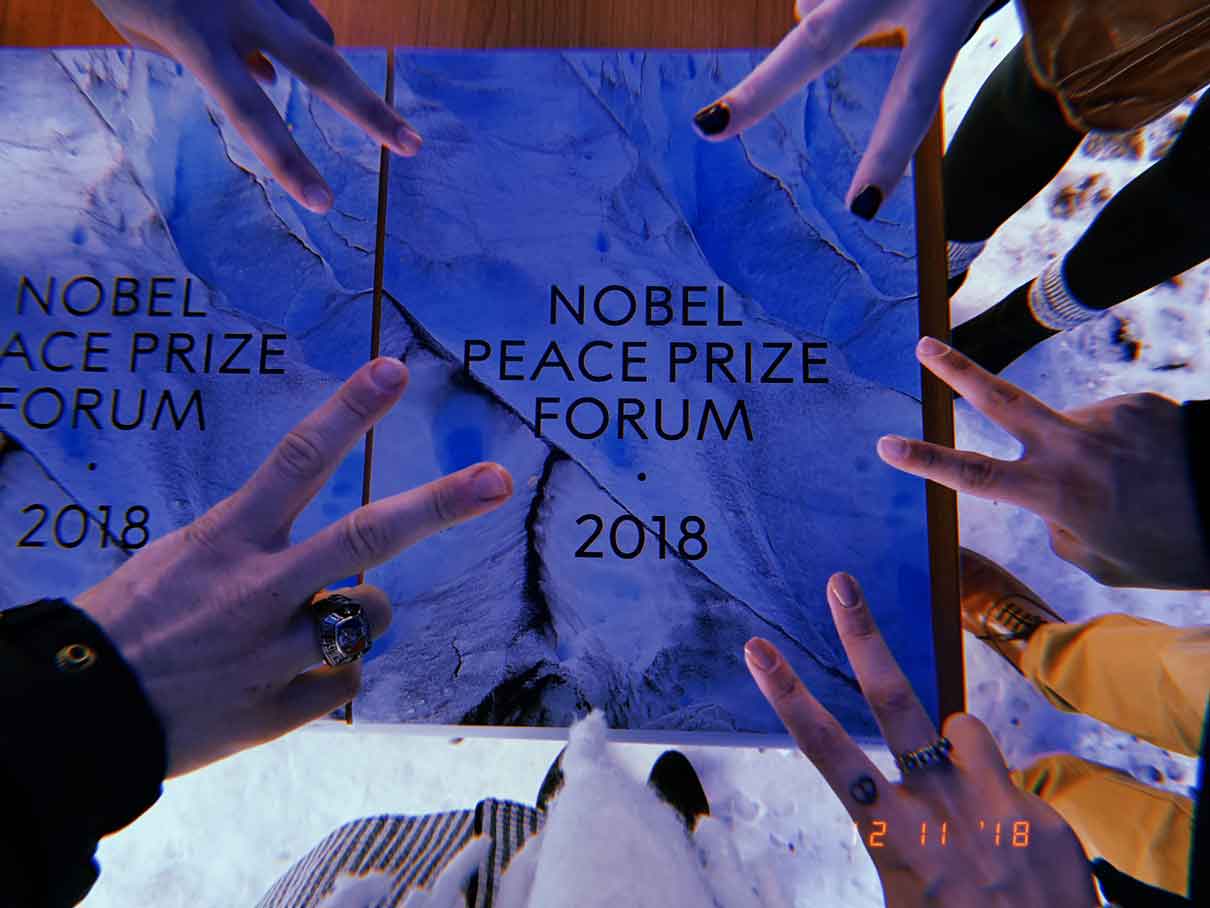 Peace signs in front of the nobel peace prize forum 2018