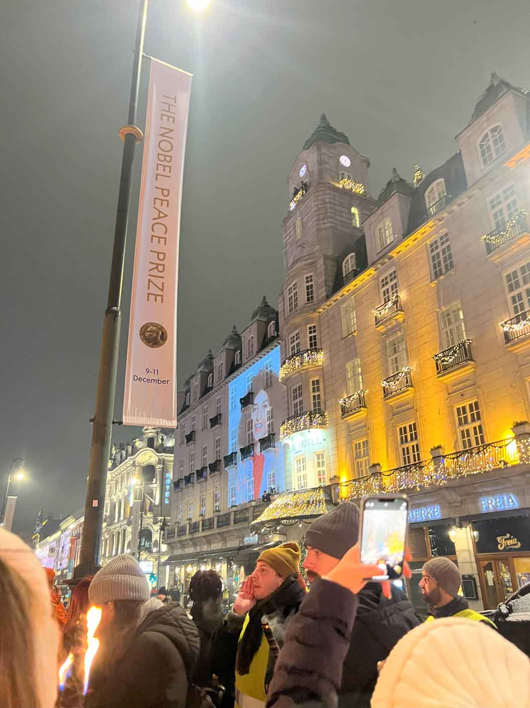 Outside crowd with a pole for THE NOBEL PEACE PRIZE 9-11 DECEMBER