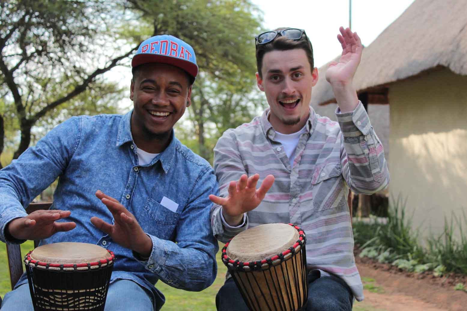 Two men drumming on bongos