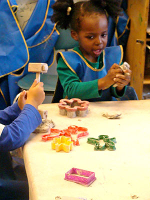 Children creating shapes with clay