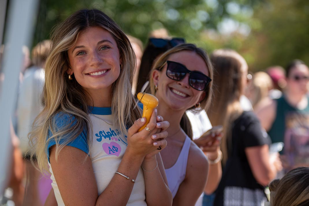 Student posing for a picture buying items
