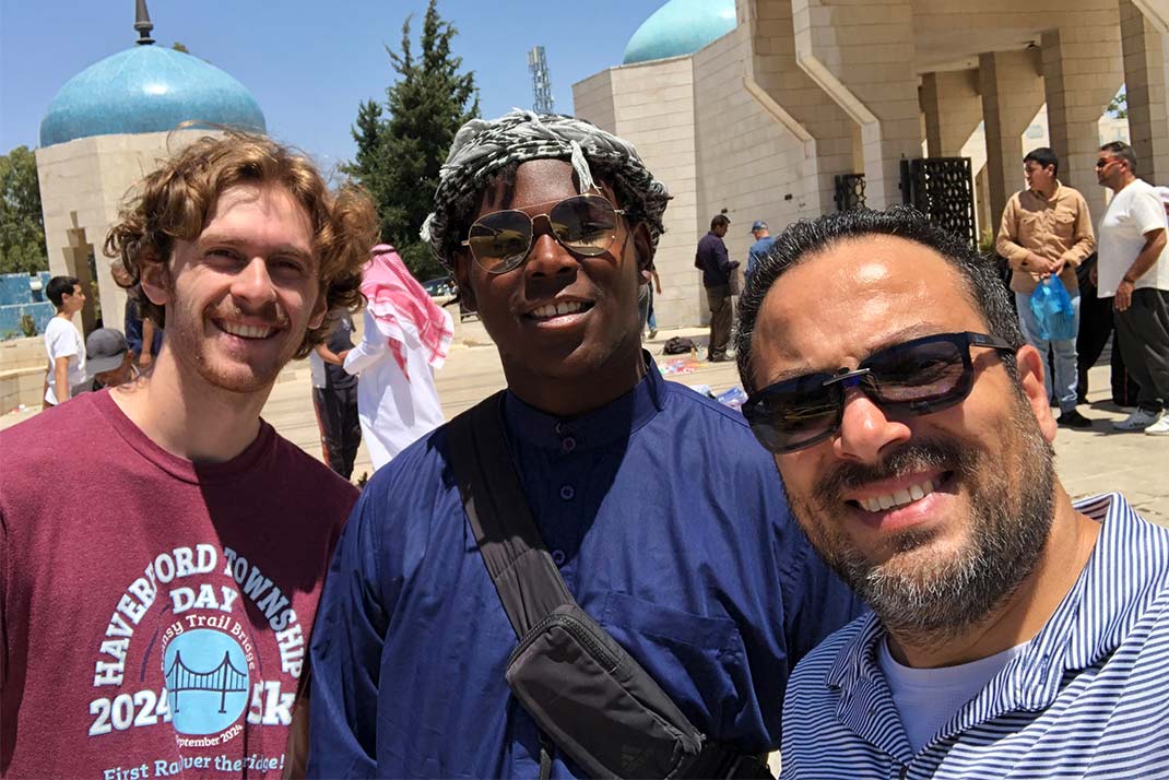 Male Student drawing on canvas.