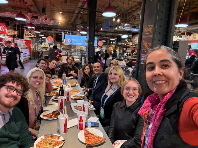 Multiple students sitting down at a table eating