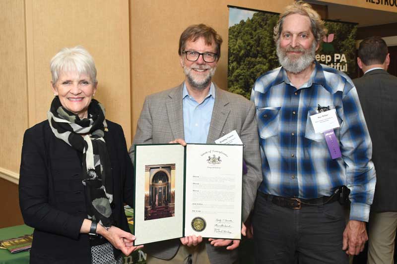 Pennsylvania Senator Carolyn T. Comitta ’74 (L) presents a Senate resolution honoring WCU’s inclusion in the Governor’s 2024 Awards for Environmental Excellence to Brad Flamm (C), WCU director of sustainability, and Nur Ritter (R), GNA stewardship manager.