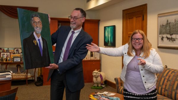 Katie Lickfield (right), local Kennett Square artist and West Chester University (WCU) alumna, presents an oil/acrylic portrait that she painted of WCU President Chris Fiorentino (left).