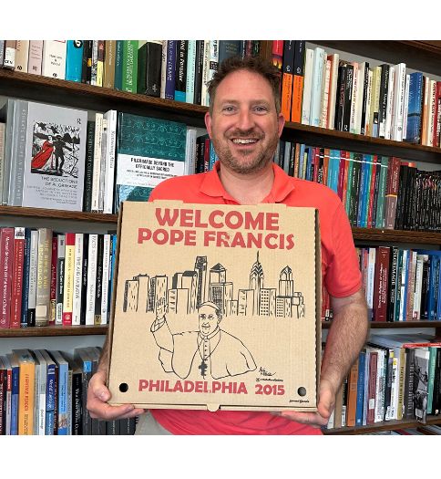 Dr. Michael A. Di Giovine, professor of anthropology at West Chester University, with a pizza box from 2015 that was created to welcome Pope Francis to Philadelphia. Dr. Michael A. Di Giovine, professor of anthropology at West Chester University, with a pizza box from 2015 that was created to welcome Pope Francis to Philadelphia.