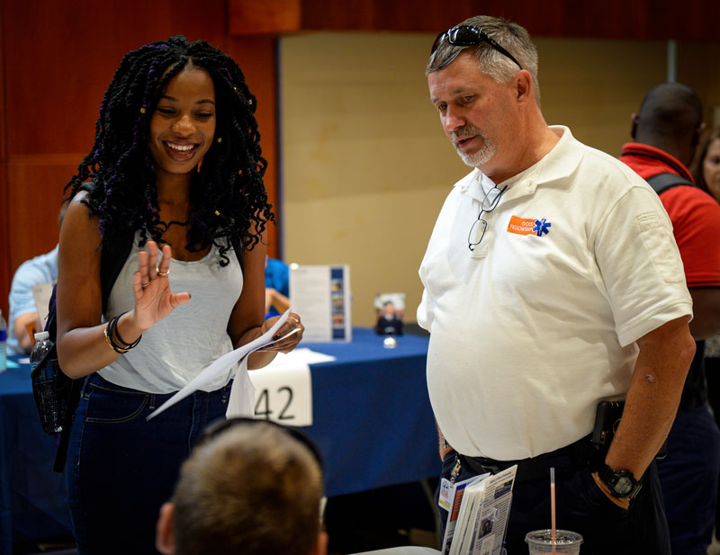 2 people standing and chatting at an event