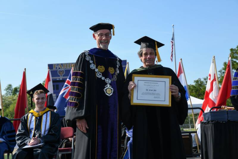 Dr. Frank Fish receiving award at commencement